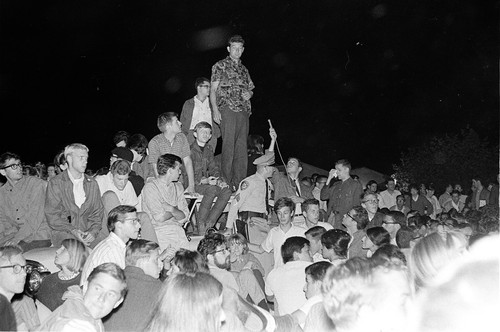 Art Goldberg and other students surrounding and on top of the policecar during night of Oct. 1, 1964
