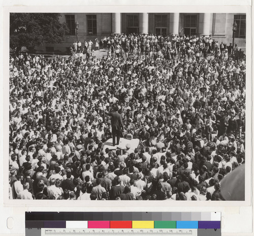 View of students in Sproul Plaza surrounding police car, October 1, 1964. Mario Savio speaking from roof of car