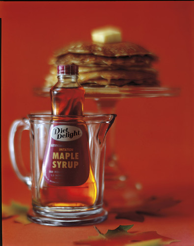 A bottle of Diet Delight maple syrup in a pitcher
